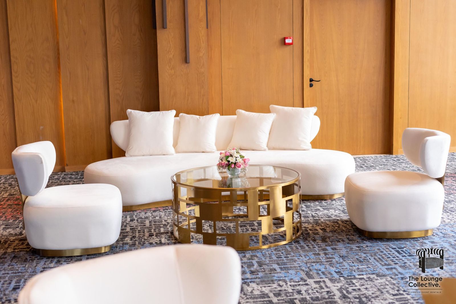 A Brushed Gold lounge with curved sofa, armchairs and gold coffee table, styled by The Lounge Collective in Nairobi