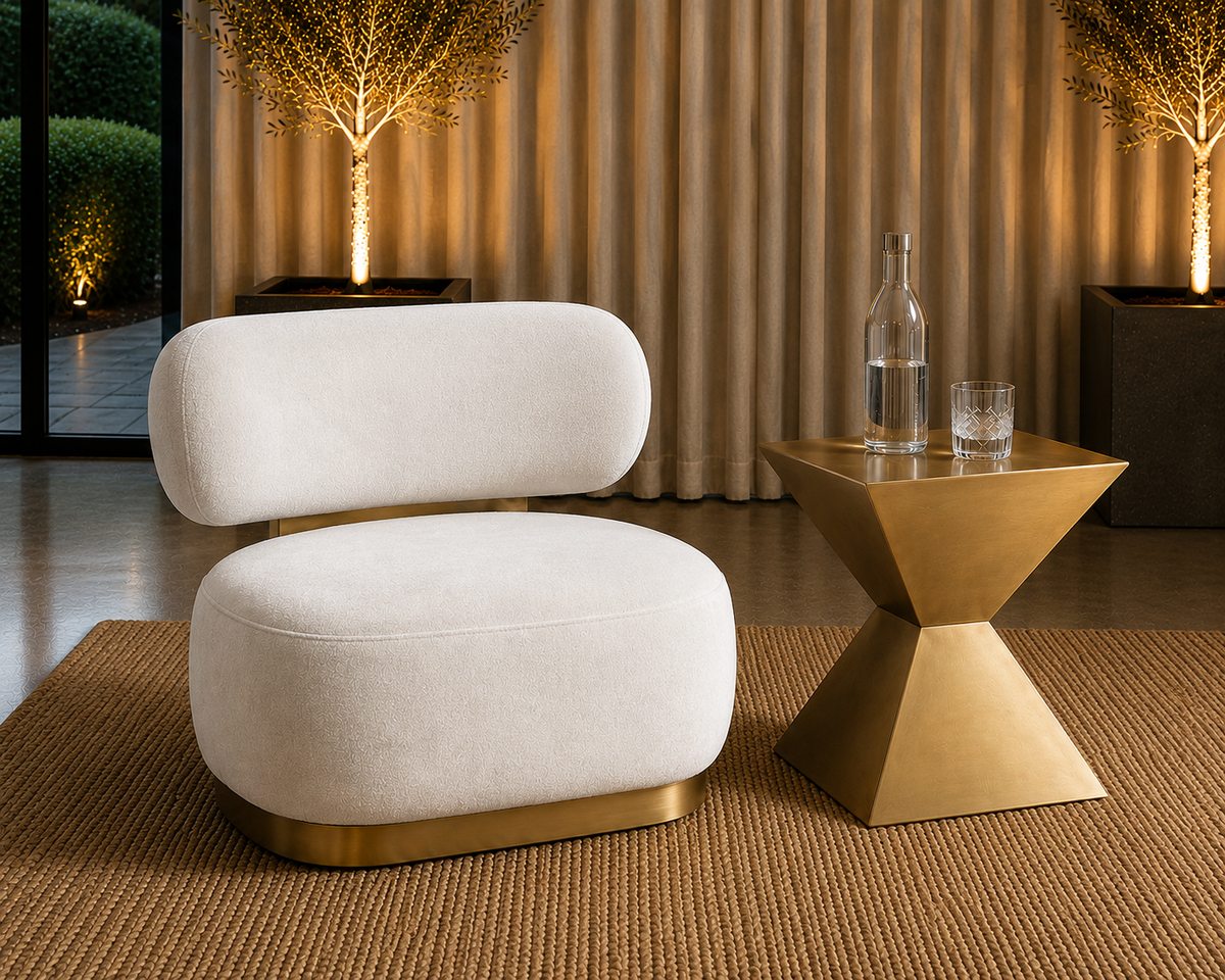 A Brushed Gold armchair and gold side table in warm evening light